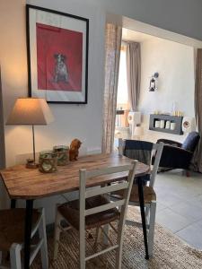 a dining room with a wooden table and chairs at Charmant duplex vue mer et étangs ! Clim / Parking in Frontignan