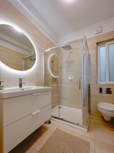 a bathroom with a shower and a sink and a toilet at 21 Townhouse in St Julians in Paceville