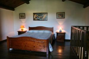 a bedroom with a wooden bed and two lamps on tables at Hotel Tenuta San Francesco in Barletta