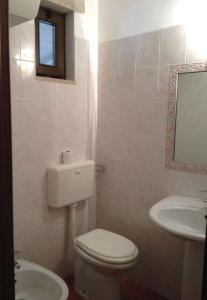 a bathroom with a toilet and a sink and a mirror at Hotel Tenuta San Francesco in Barletta