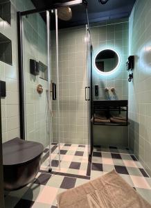 a bathroom with a shower with a toilet and a sink at Hotel Nicolaas Witsen in Amsterdam