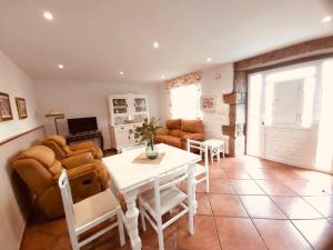 a living room with a table and a couch at Casa Pereiro playa de Esteiro in Viveiro