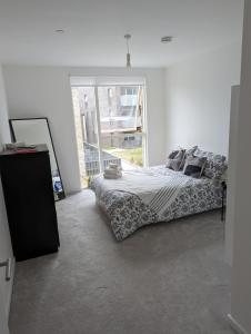 1 dormitorio con cama y ventana grande en Kingwood apartaments, en Londres