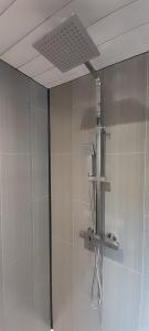 a shower with a glass door in a bathroom at Wisteria Barn, Trewethen, St Teath, nr Port Isaac in Saint Teath