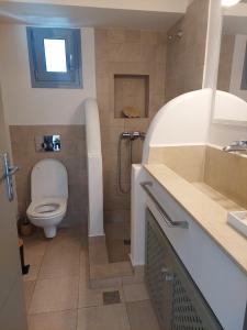 a bathroom with a toilet and a sink at Villa Kairos- Aegean Sea in Masouri