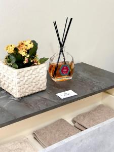un tavolo con due fiori e un vaso sopra di B&B La Reggia del Sol a Trani