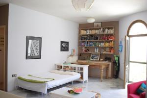 a living room with a bed and a desk at Ilian Studios in Parga