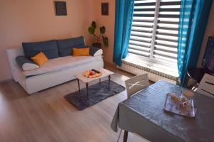 - un salon avec un canapé et une table dans l'établissement Apartment Potnar Z, à Malinska