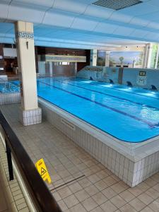 a large swimming pool in a large building at Ferienwohnung Bergzeit mit Sauna und Pool in Sankt Englmar