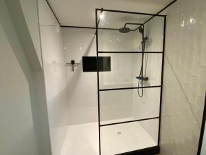 a shower with a glass door in a bathroom at Suite Spot Houten in Houten