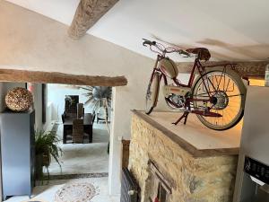 a bike is hanging on top of a brick fireplace at Bergerie Truphemus de Savoillan in Savoillan