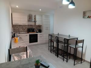 a kitchen with a counter and a table and chairs at D'Orazio mare e dintorni in Trapani