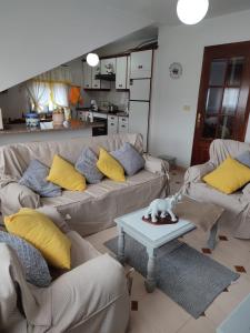 a living room with two couches and a table at Casa da Rapadoira 