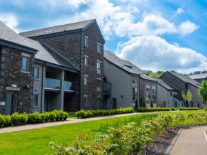 a row of apartment buildings with a green lawn at Pass the Keys Exceptional 3 Bedroom River View Apartment in Ulverston