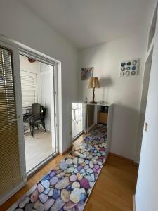 a living room with a carpet of rocks on the floor at Apartment XENA Novi Vinodolski - Balcony and Sea View - first row to the sea - free wifi - free parking in Novi Vinodolski