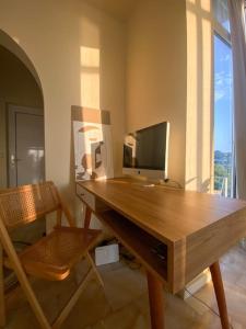 a wooden desk with a computer on top of it at Best View Stylish Penthouse in Corfu Town