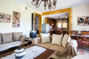 a living room with a couch and a table at VILLA ROSSA in Mesimvría