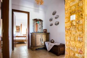 a hallway with a mirror and a dresser in a room at VILLA ROSSA in Mesimvría