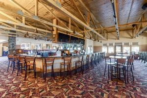a bar in a room with tables and chairs at Chula Vista Condo 2408 in Wisconsin Dells