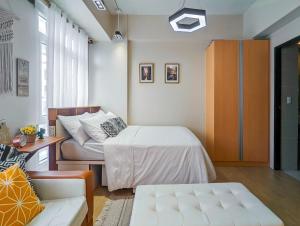 um quarto com uma cama, um armário e um sofá em NAIA Airport Terminal 3 Studio Condo Casino Nightlife em Manila