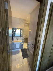 a bathroom with a sink and a mirror at Superbe appartement luxueux idéalement situé à la marina saidia in Saïdia