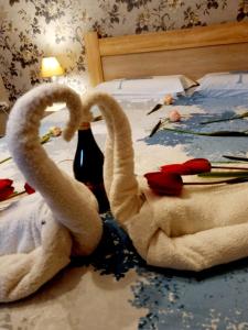 two towel swans sitting on top of a bed at Apartments Krstos place in Kotor