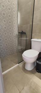 a bathroom with a toilet and a shower at Filoxenia Apartments in Mytilene