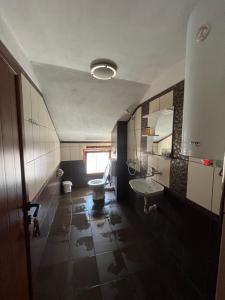 a bathroom with a toilet and a sink and a mirror at Daniel Guest House in Nesebar