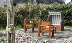two rocking chairs sitting on a wooden deck at FH Kormoran in Ostseebad Karlshagen