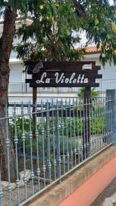 Un panneau qui dit la violita derrière une clôture dans l'établissement La Violetta, à Camerano