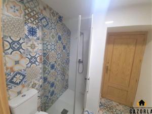 a bathroom with a toilet and a glass shower at CASA CARMELA in Cazorla