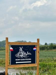 a sign for a now down rollka in a field at Nowy Dom Polska in Magnuszew