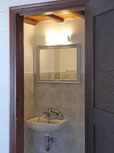 a bathroom with a sink and a mirror at Philoxeno Traditional house - Ano Syros in Ano Syros