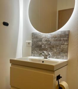 a bathroom with a sink and a mirror at Bjarkarholt Guesthouse in Bjarkarholt