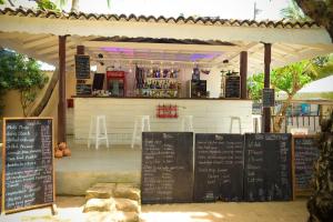 a restaurant with a bar with chalkboards in front of it at Kingfisher in Unawatuna