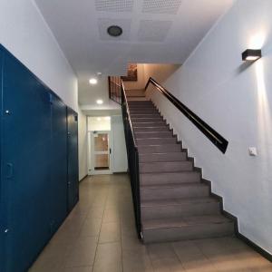 a hallway with a staircase in a building at Aparthotel Meseguer in Alcañiz