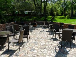a group of tables and chairs sitting in a patio at Dom Młynarza in Żukczyn