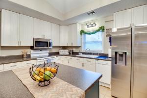 a kitchen with a bowl of fruit on a counter at Bright Guyton Home with Private Yard and Hot Tub! in Port Wentworth
