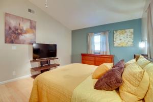 a bedroom with a bed and a flat screen tv at Bright Guyton Home with Private Yard and Hot Tub! in Port Wentworth