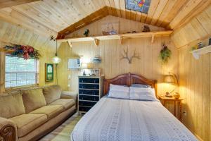 a bedroom with a bed and a couch in a room at Emory Studio Cabin with Lake Fork Boat Access! in Emory