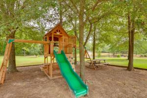 a playground with a tree house and a slide at Emory Studio Cabin with Lake Fork Boat Access! in Emory
