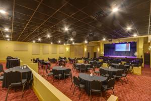 a banquet hall with tables and chairs and a stage at Swim, Golf and Bowl - Loretto Vacation Rental Apt! in Loretto +30 photos