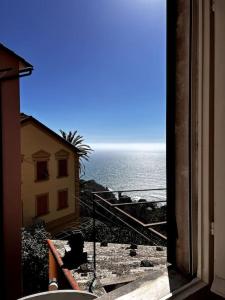 a view of the ocean from a window of a building at Flat with sea view and garden in Framura