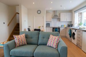 a living room with a blue couch in a kitchen at The Old Threshing Barn in Newark-on-Trent