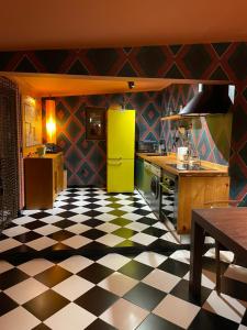 a kitchen with a yellow refrigerator and a checkered floor at Casa do Sobro in Santo Estêvão