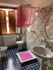 a bathroom with a sink and a pink mat on the floor at Villa prestigiosa ampie metrature in Altipiani di Arcinazzo +14 photos