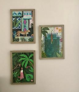 trois images encadrées sur un mur dans l'établissement Precioso Apartamento: La Luz de Cádiz, à Cadix