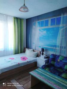 a bedroom with two beds and a bench in it at Къща за Гости Тера in Kiten