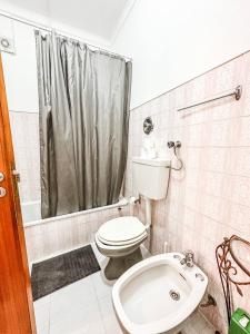 a bathroom with a toilet and a shower at Casa da Mariazinha in Costa da Caparica
