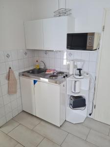 a small kitchen with a sink and a stove at Ferienwohnung Ribnitz-Damgarten in Ribnitz-Damgarten